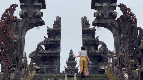 balinese temple offering ritual: traditional canang sari at besakih mother temple, ubud, bali