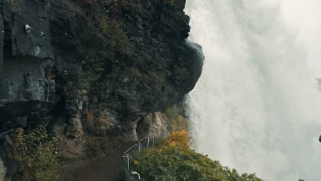 a narrow walkway under the famous steindalsfossen waterfall