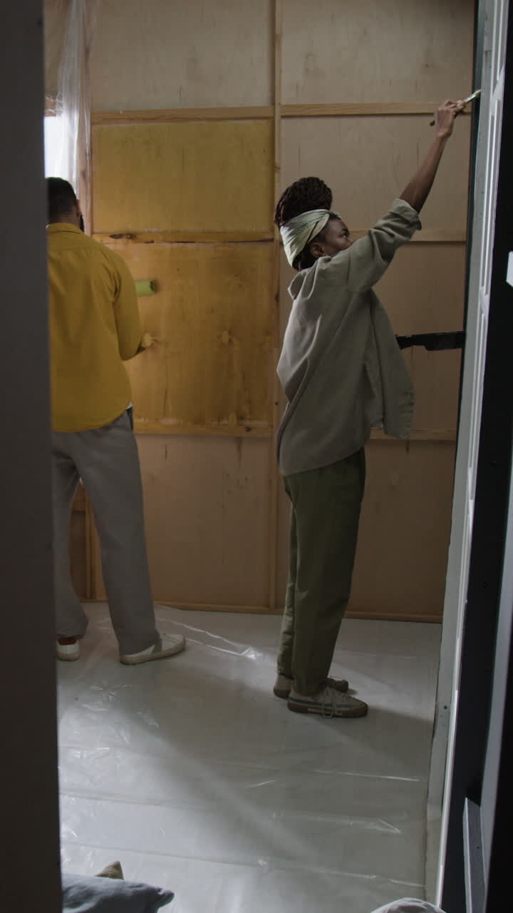 People painting a room during a renovation