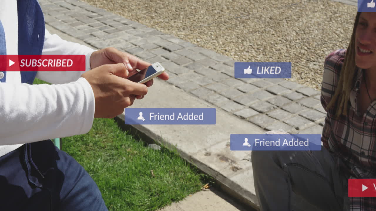 Animation of social media icons with texts over diverse people using smartphone