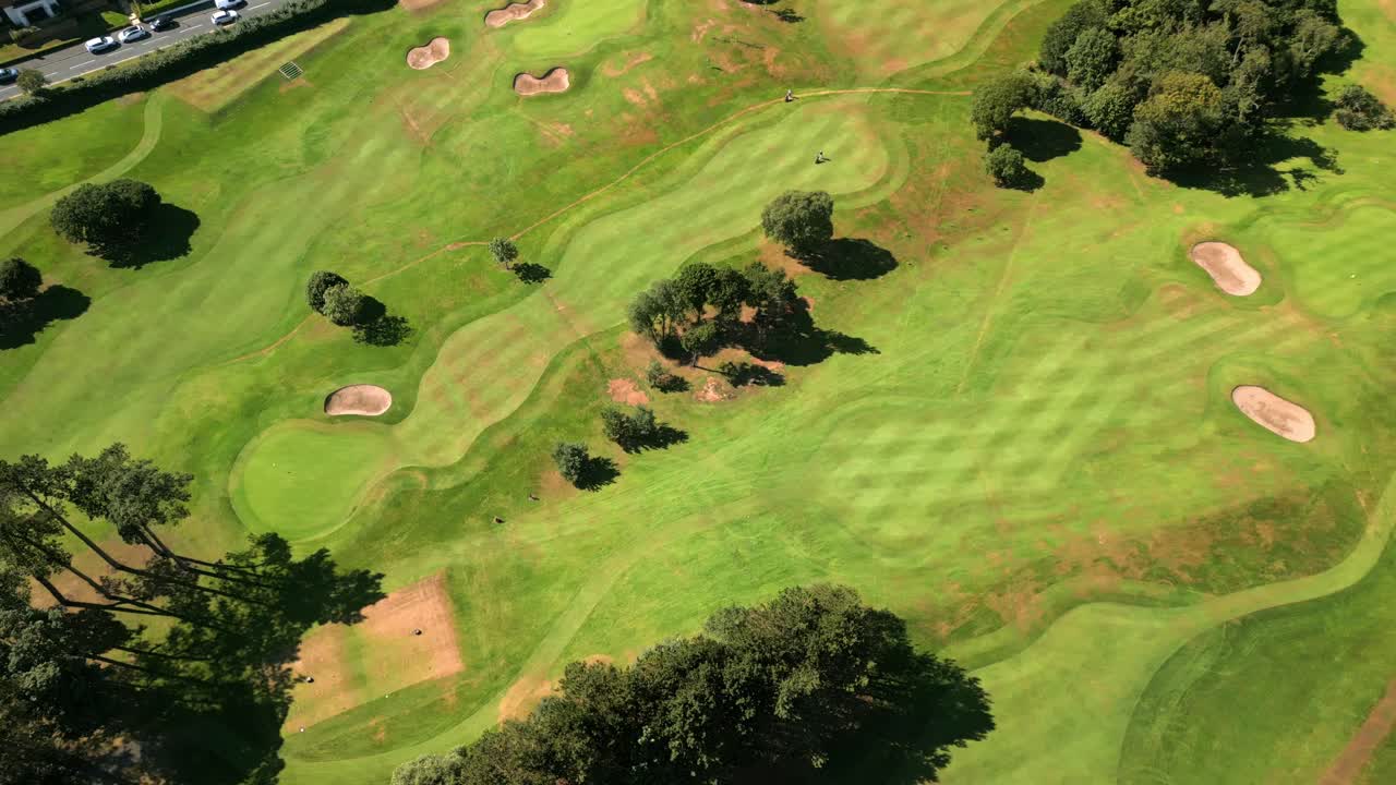Top-down 4K 60FPS aerial of Helen's Bay Golf Club in County Down, Northern Ireland on a bright summer day. Produced with Rec709 color
