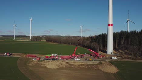 construction site of a wind turbine green energy generation - aerial drone shot sideways