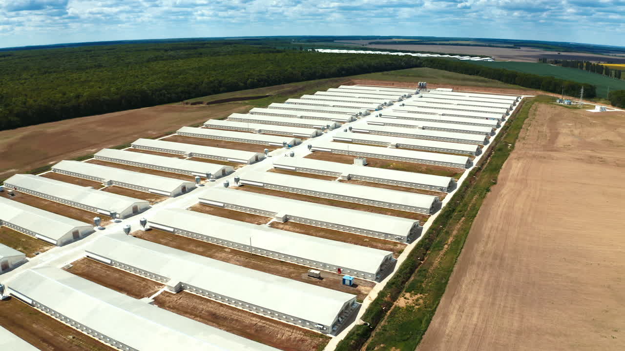 Modern manufacture complex on the field. Panoramic view of industrial plant. Flight over the farm on nature background. Aerial view.