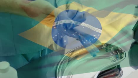 Animation-of-flag-of-brasil-waving-over-surgeon-in-operating-theatre