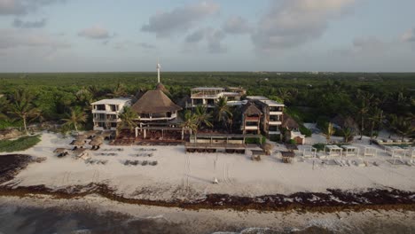 Backward-shot-of-the-resort-at-Amansala,-Tulum,-Mexico_drone-view