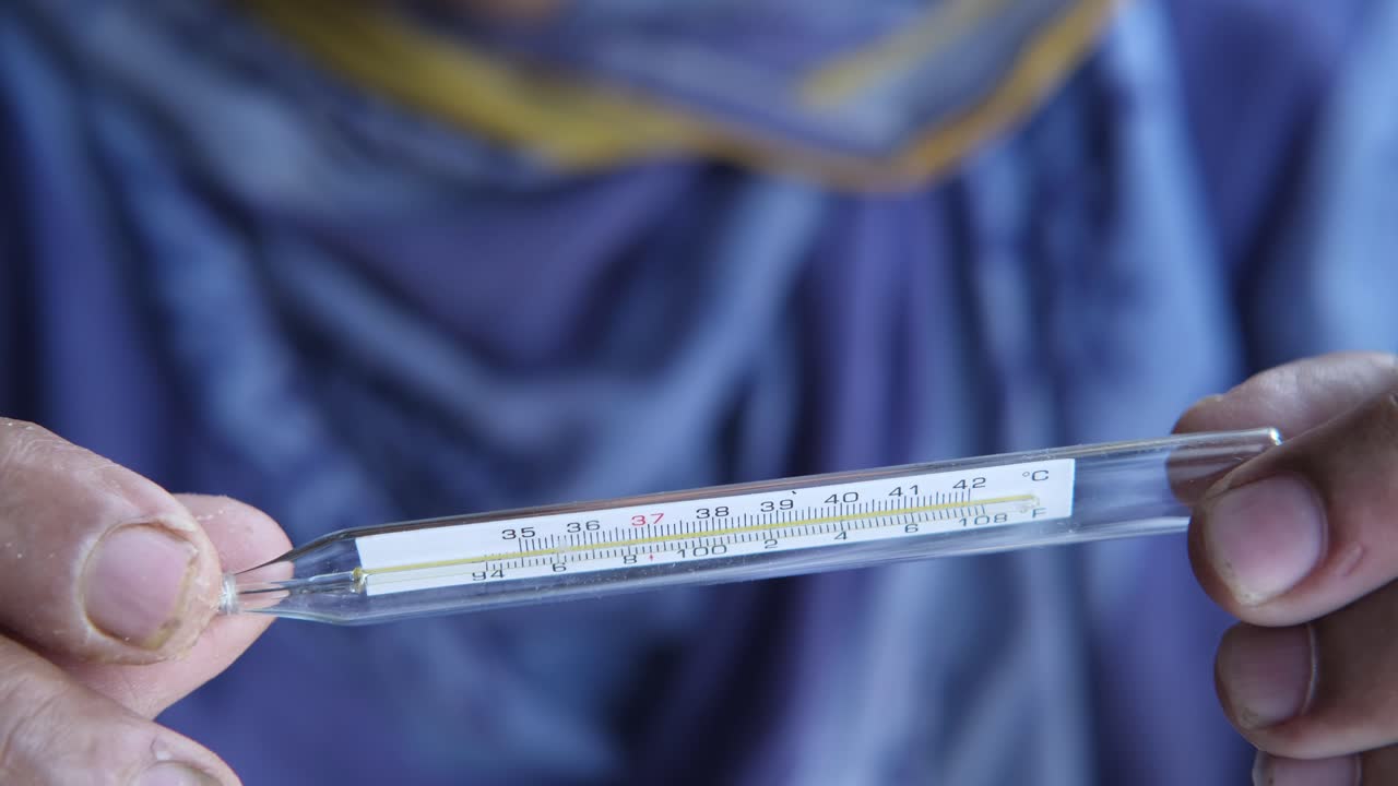 온도계를 들고 있는 사람