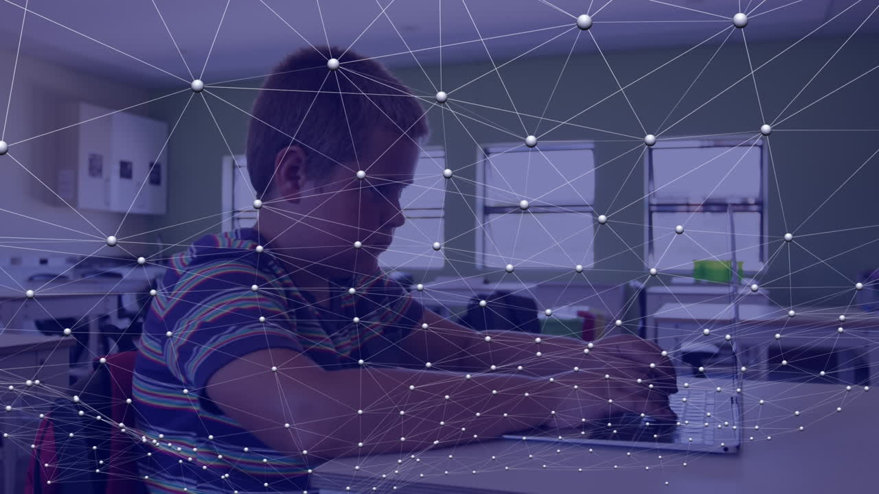 Animation of network of connections over caucasian boy using laptop in classroom