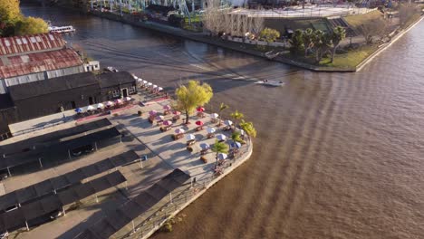 aerial drone tracking view of motorboat departing from tigre area on lujan river in buenos aires, argentina