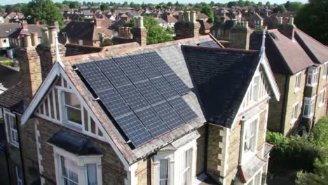 harnessing renewable energy: a stunning aerial view of a house with solar panels on the roof surrounded by a residential neighborhood