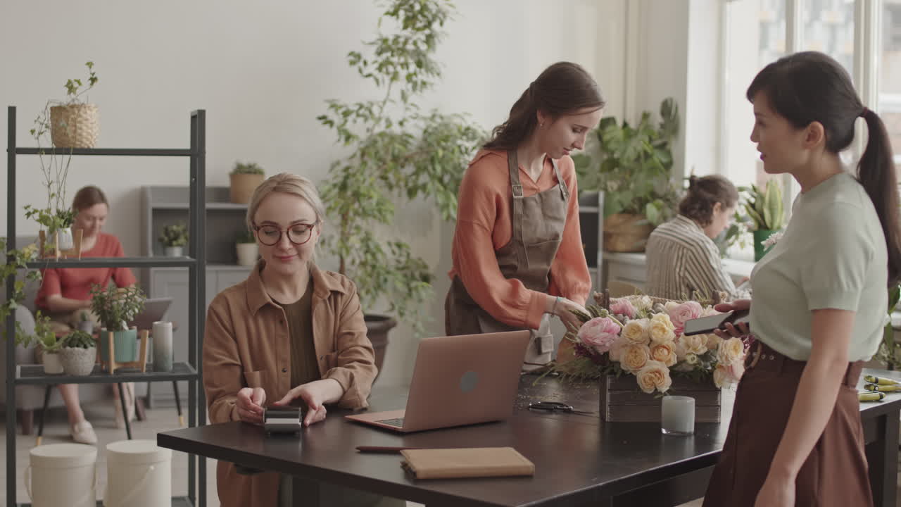 Woman Buying Flowers in Plant Shop