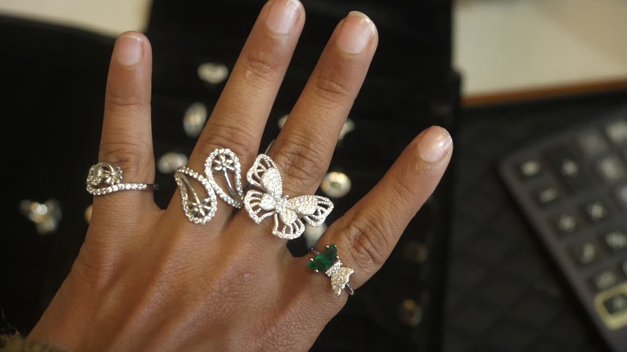 Designer and trendy silver finger rings on hand studded with lab grown diamonds, Closeup