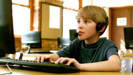 Pupil-typing-on-a-laptop-while-wearing-headphone