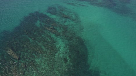 Reef-Rocks-Seen-Underwater-Through-Clear-Blue-Sea