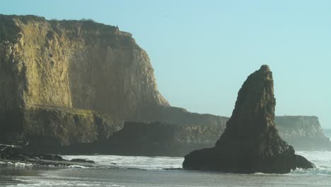 Waves-Crashing-into-Rock-Formations-on-Beach-in-Davenport,-California