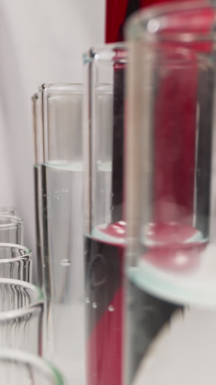 Scientist in latex gloves takes test tube with red liquid from rack in laboratory slow motion. Probe lens shot of scientific researching closeup