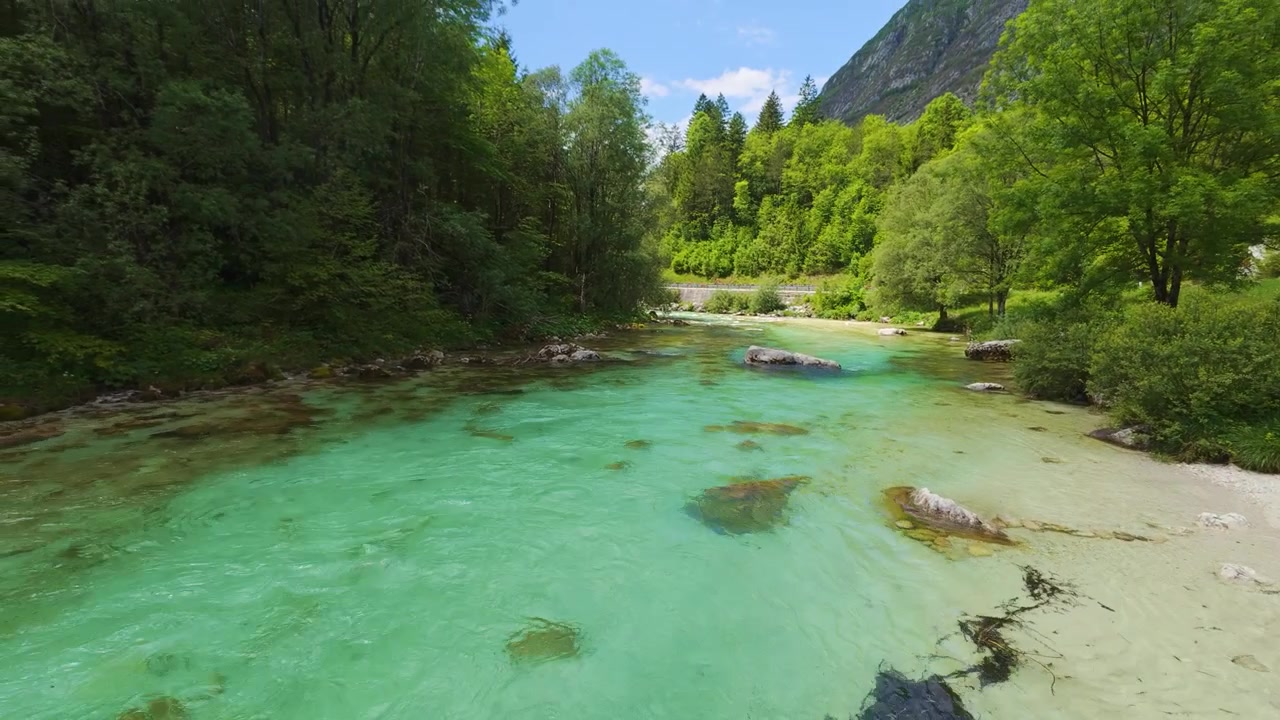 Wide Shot View of Emerald Soča River Flowing Through Trenta Valley in Slovenia Landscape