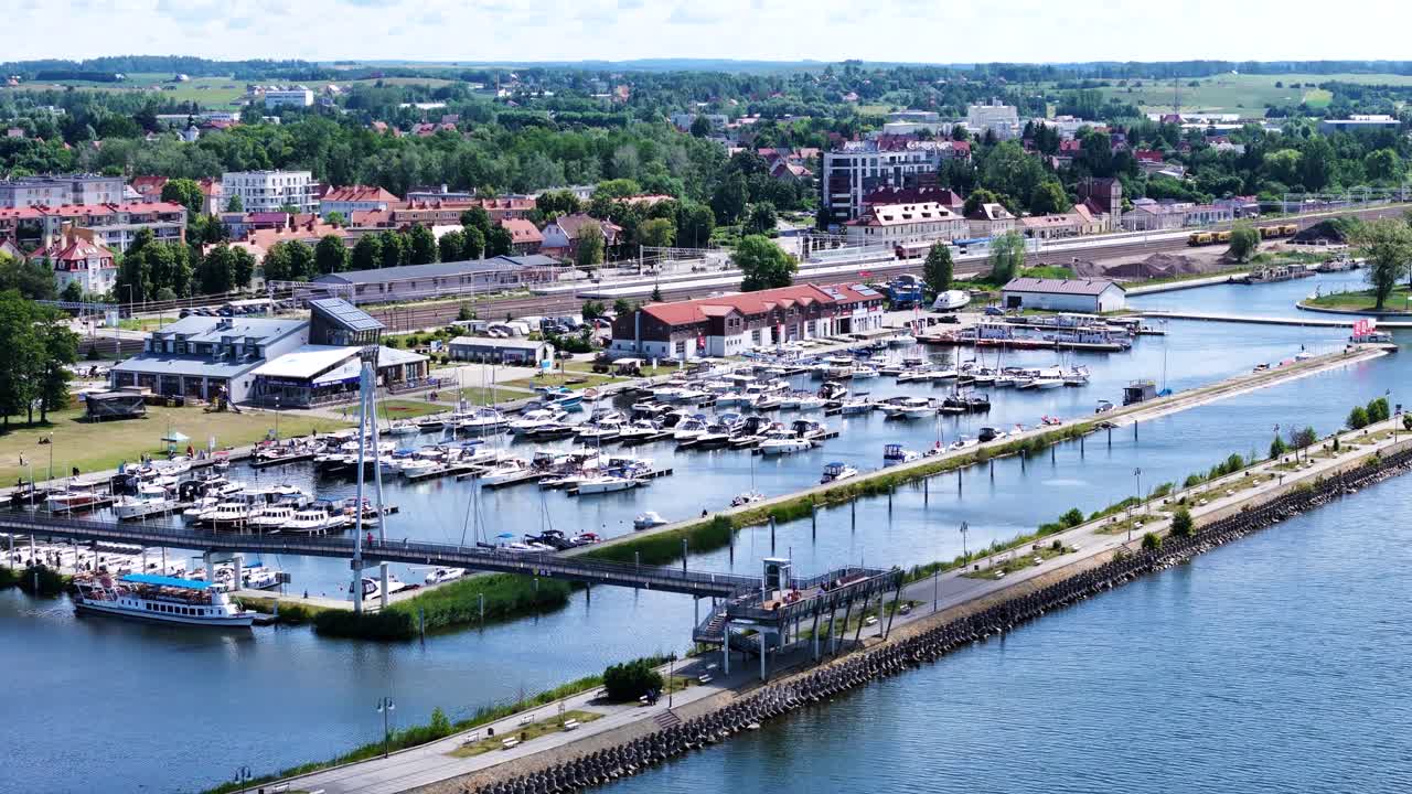 Gizycko city marina full of yachts and cityscape in background, aerial view