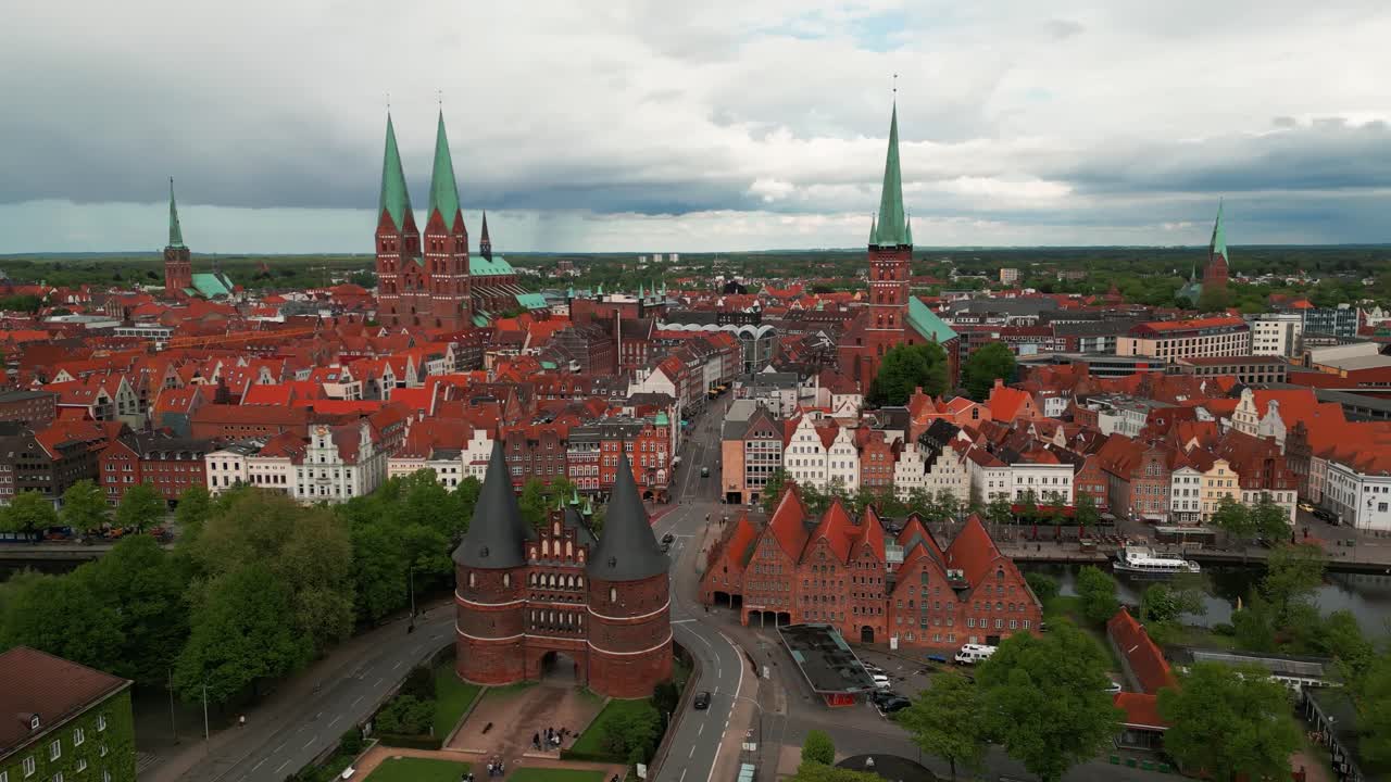 aerial shot around holstentor medieval gate with Lubeck city center in the background on an overcast day in Germany