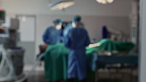 Blur,-surgery-and-team-of-doctors-in-operation