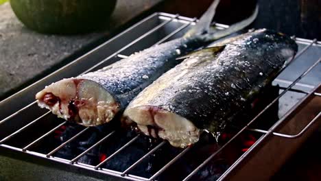 fresh fish on a charcoal grill called inihaw or sinugba, an authentic traditional filipino local dish in the philippines