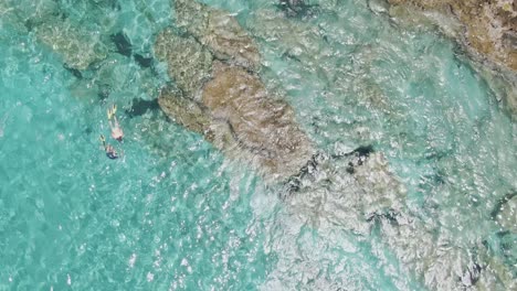 group of scuba divers near coastline of crete island, aerial top down view