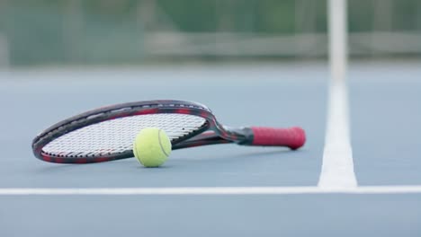 Close-up-of-tennis-racket-and-ball-on-outdoor-tennis-court,-slow-motion