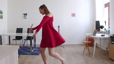 happy girl dancing and sweeping floor in living room, tidying can be fun