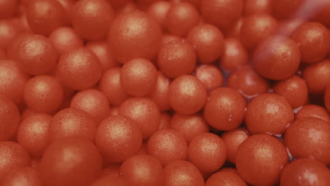 close-up view of many small, red, shiny balls