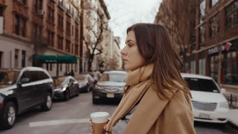 woman walking in the city with coffee