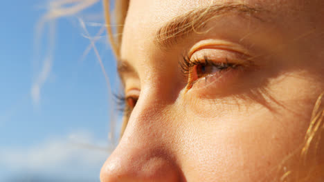 Close-up-of-young-caucasian-woman-standing-at-beach-4k