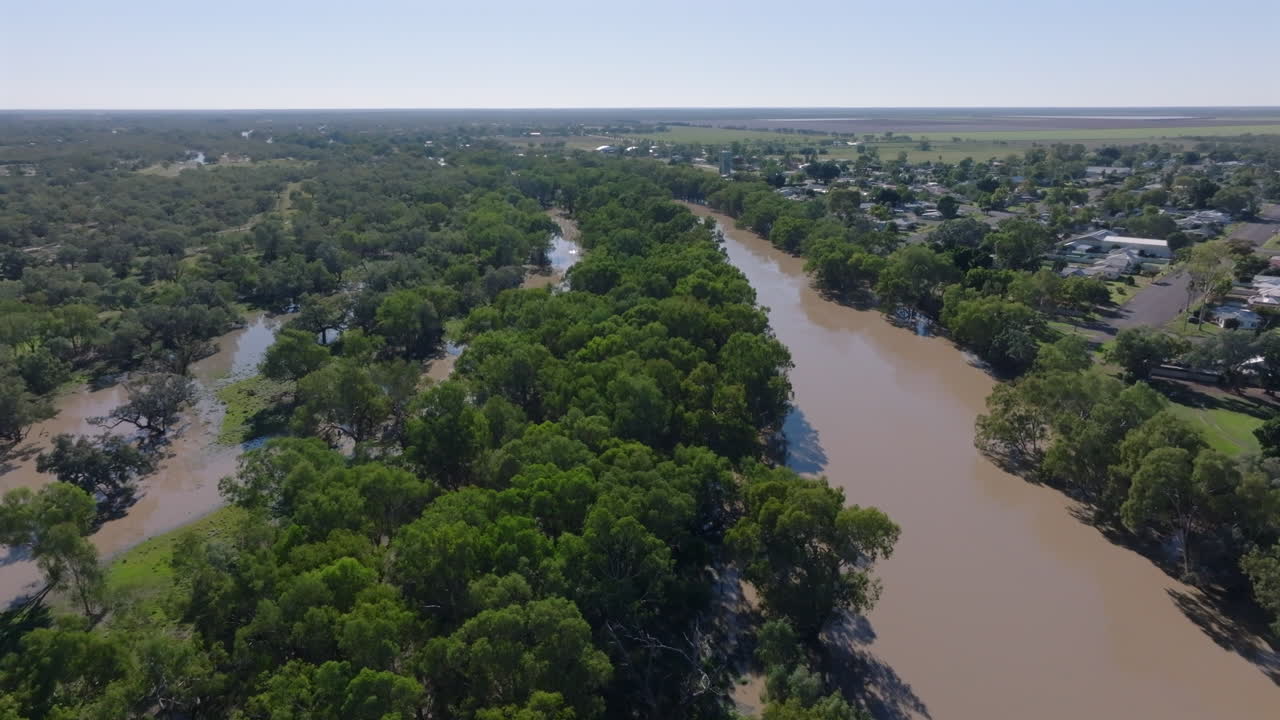 Aerial: Drone shot of a full Darling River that has burst it's banks at Bourke, Outback NSW, Australia