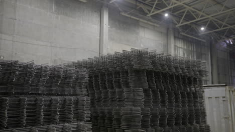 stacked steel reinforcement bars in a warehouse