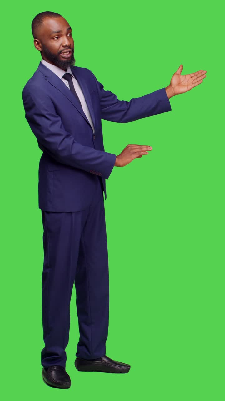 Vertical video: Side view of male entrepreneur creating advertisement on camera