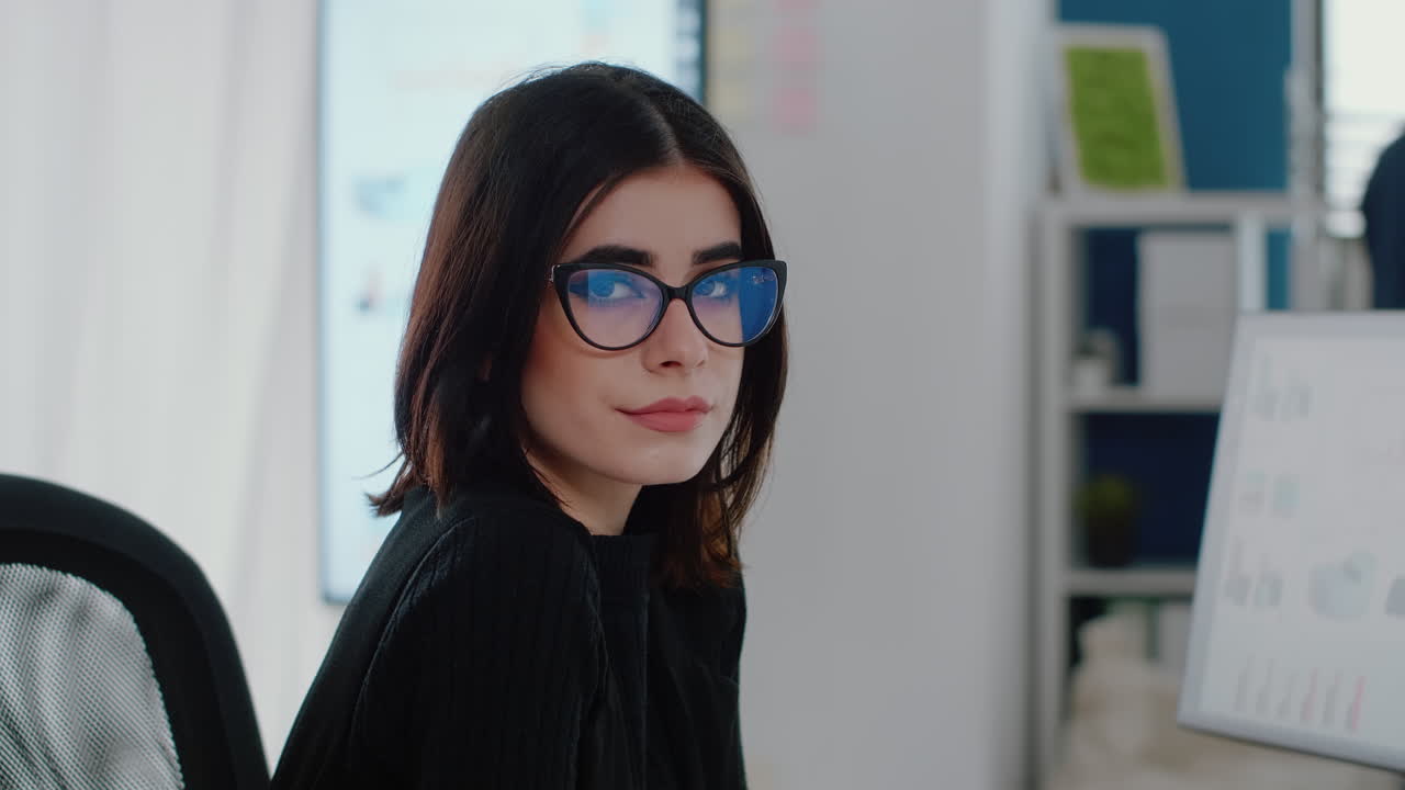 Portrait of woman with business job sitting at office desk