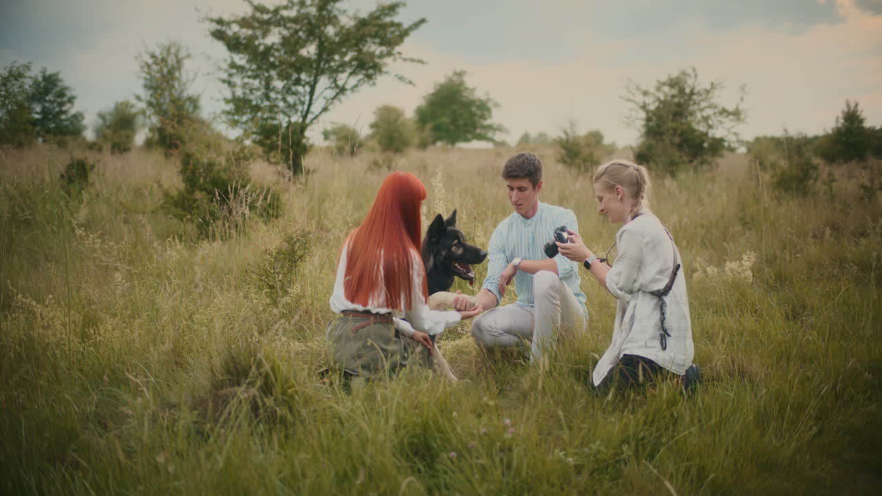 People with dog in field
