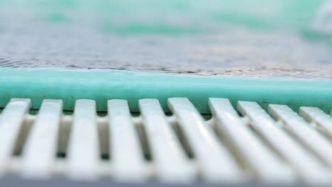 close up of an edge of swimming pool with white drain