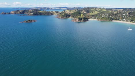 yacht sailing on mawhitipana bay near palm beach in waiheke island, hauraki gulf, auckland province, new zealand