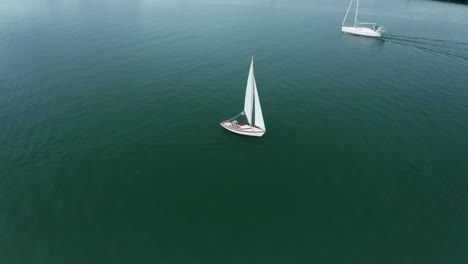 Two-boats-pass-on-the-bay-marina-lane-on-a-sunny-cloudy-day