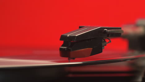 slider-move-on-a-red-retro-record-players-needle-and-a-vintage-vinyl-music-album,-right-to-left