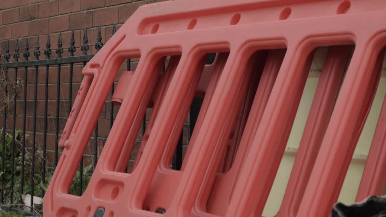 Red road traffic crash barriers medium tilting shot