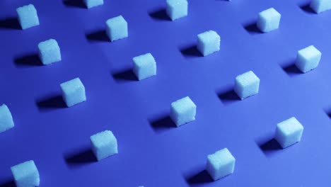 trucking 4k view of a unique cubic background with white sugar cubes arranged in rows on a dark blue background, 3d effect