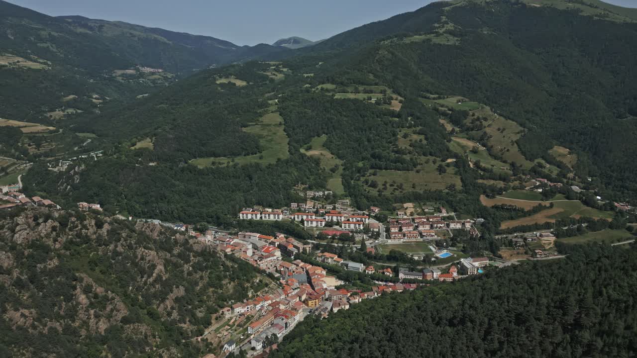 Ribes de freser, a charming town nestled amidst the majestic pyrenees mountains, showcases its traditional architecture and serene atmosphere, surrounded by lush greenery and rolling hills