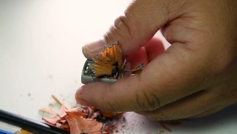 Footage-of-hands-slowly-sharpening-a-pencil-and-some-coloured-pencils-with-a-Wedge-Pencil-Sharpener