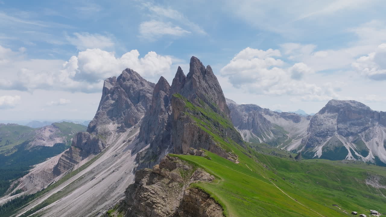 Seceda ridge towers over dramatic cliffs in northern Dolomites with aerial sunrise establishing