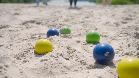 close-up view of some colorful petanque balls on the beach on a sunny day