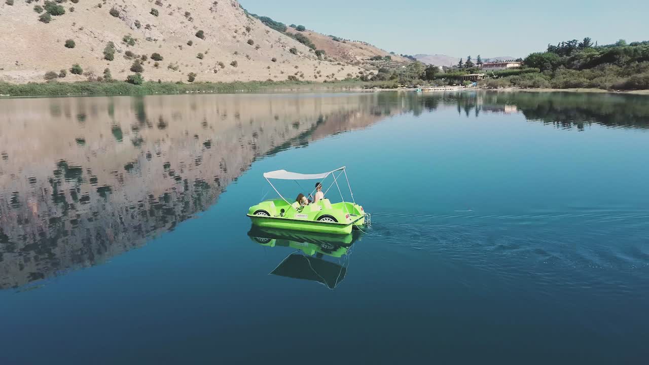 Paddle boat aerial view with crystal clear water and clear reflection