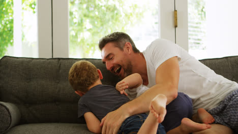 padre e hijos divirtiéndose en el sofá 4k