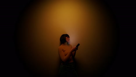 woman using phone in a dimly lit room