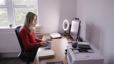 woman working at her desk in her home office