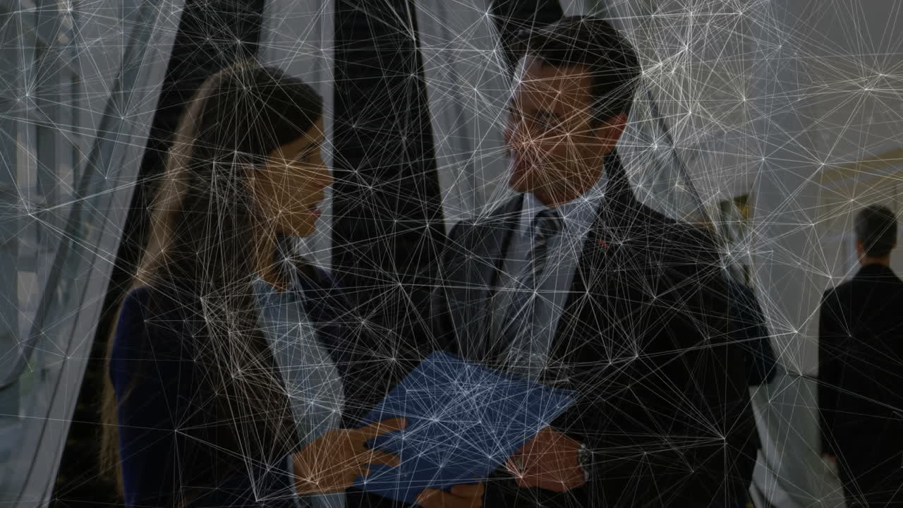 Colleagues examining blue folder in corporate lobby, with animated chart and icon overlays